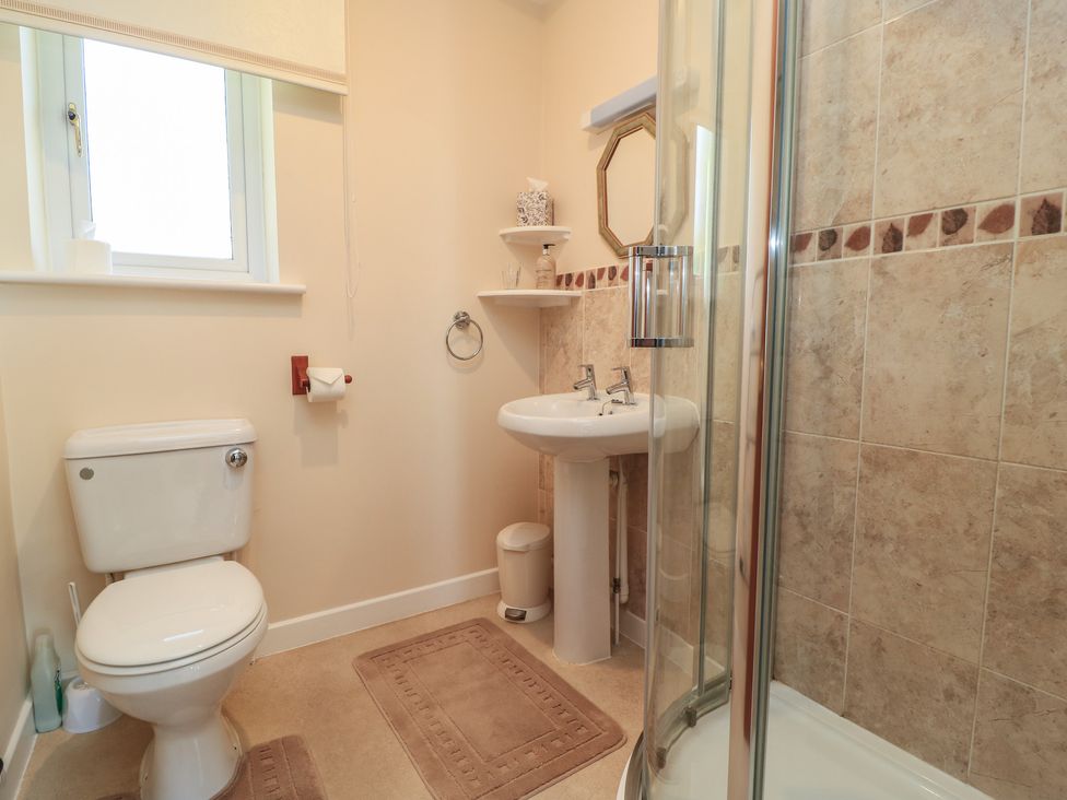 A bathroom with a toilet, sink, and shower at Willow Barn in Cucklington near Wincanton