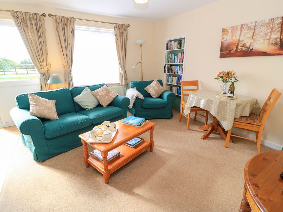 A living room with a sofa and dining table at Little Barn in Cucklington near Wincanton