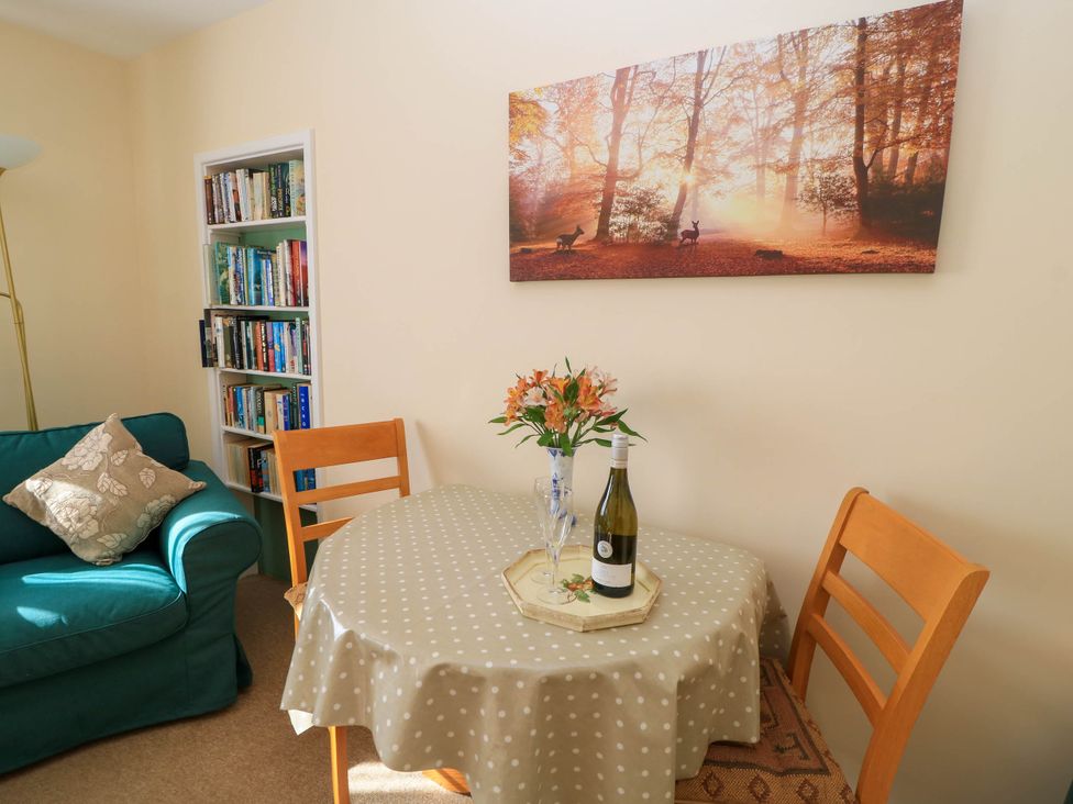 A dining room with a table and chairs at Little Barn in Cucklington near Wincanton