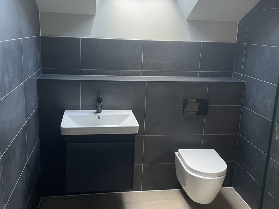 A bathroom with a sink and toilet at 1 New Dairy Barn