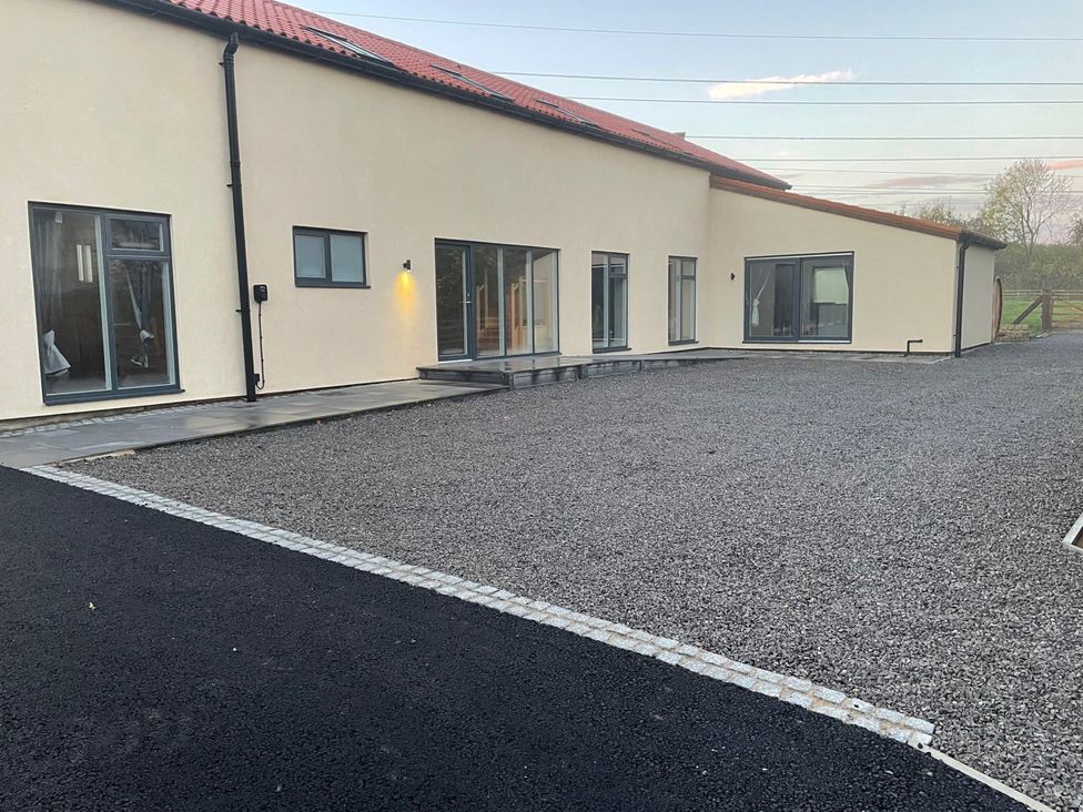 An exterior view of a modern building with gravel area at 1 New Dairy Barn Croxdale