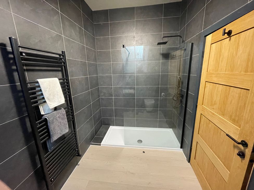 A bathroom with a shower and towel radiator at 1 New Dairy Barn in Croxdale