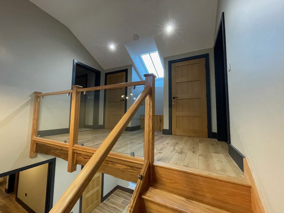 A hallway with stairs and doors at 1 New Dairy Barn Croxdale
