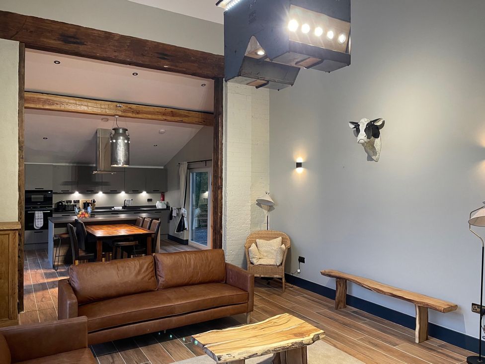 A living room with a sofa and dining area at 1 New Dairy Barn in Croxdale