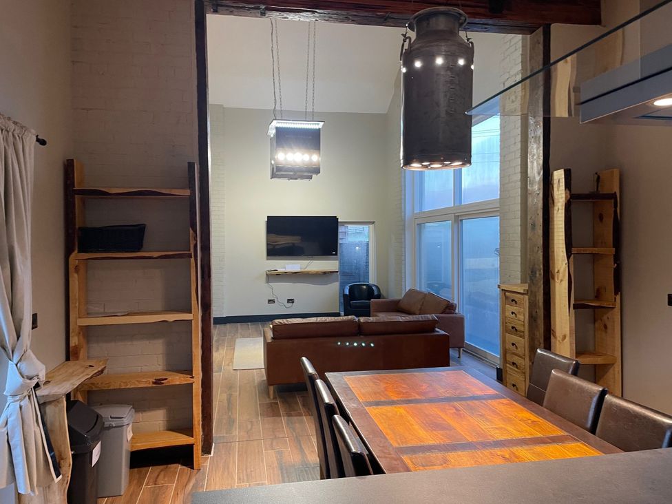 A living room with a sofa and television at 1 New Dairy Barn in Croxdale