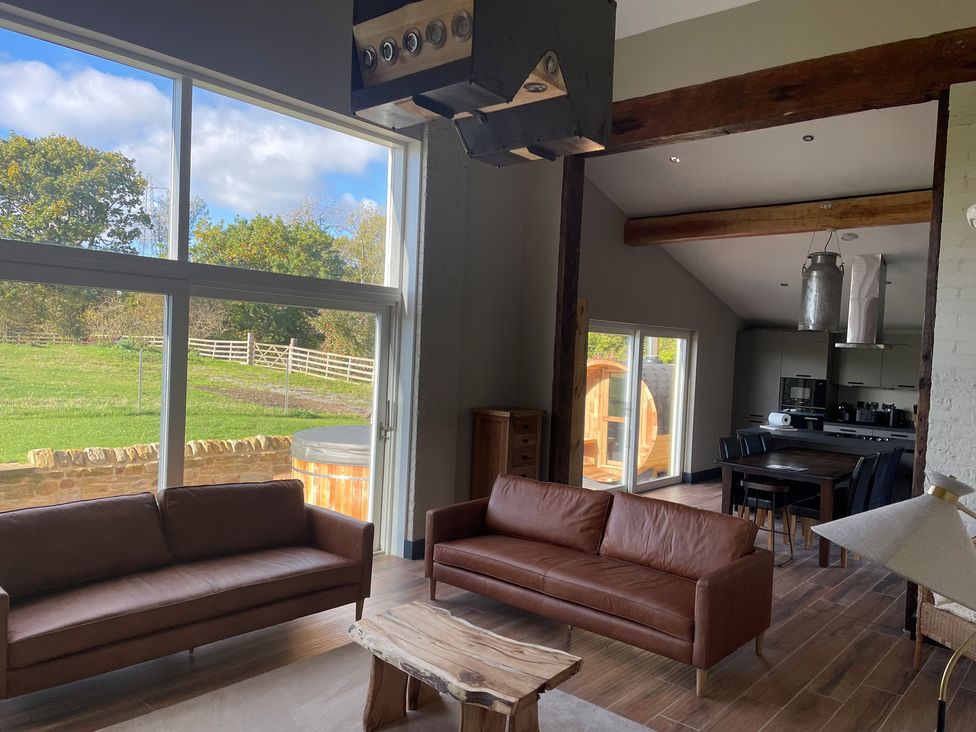 A living room with sofas and a coffee table at 1 New Dairy Barn in Croxdale