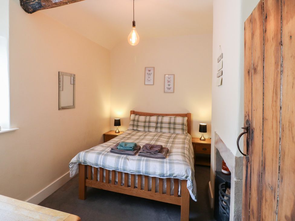 A bedroom with a bed and bedside tables at Milford Cottage in Milford near Duffield