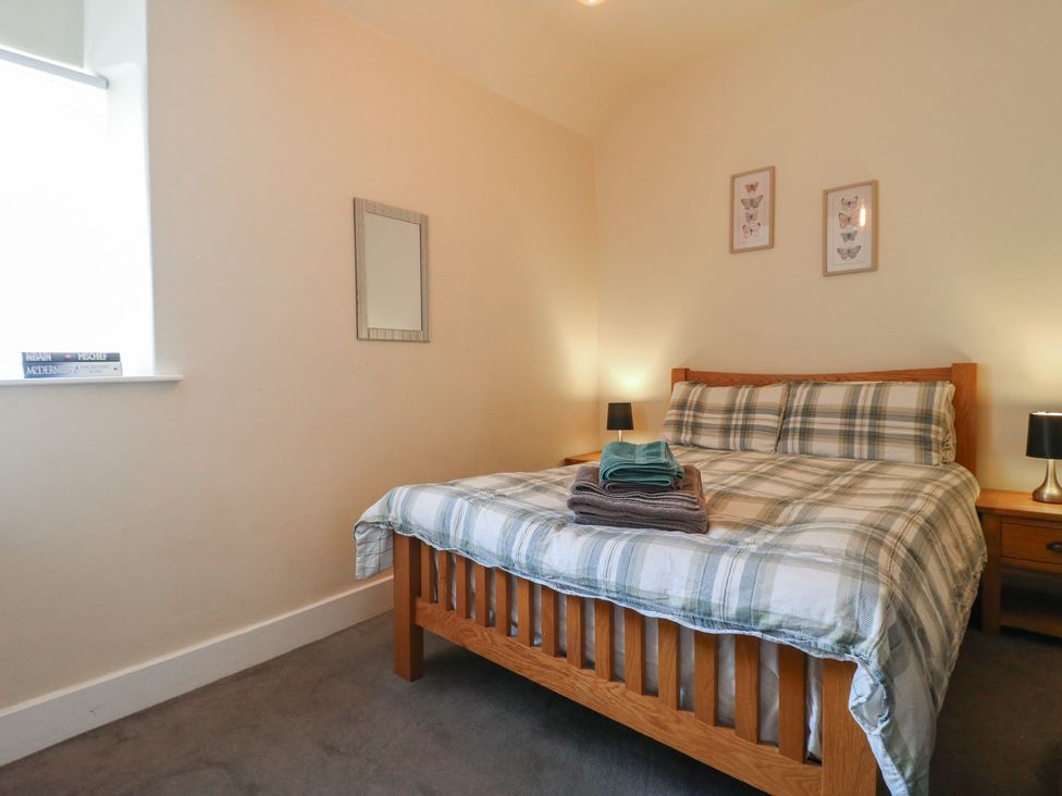 A bedroom with a bed and bedside lamps at Milford Cottage in Milford near Duffield