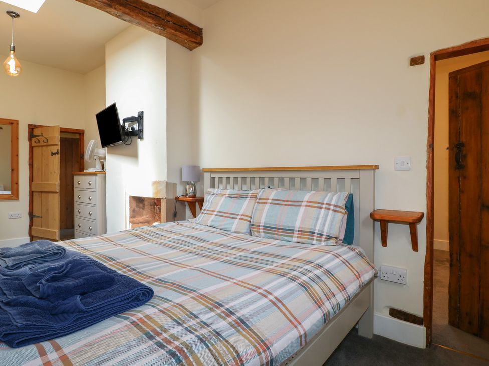A bedroom with a bed and dresser at Milford Cottage in Milford near Duffield