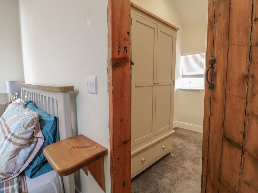 A bedroom with a bed and wardrobe at Milford Cottage in Milford near Duffield
