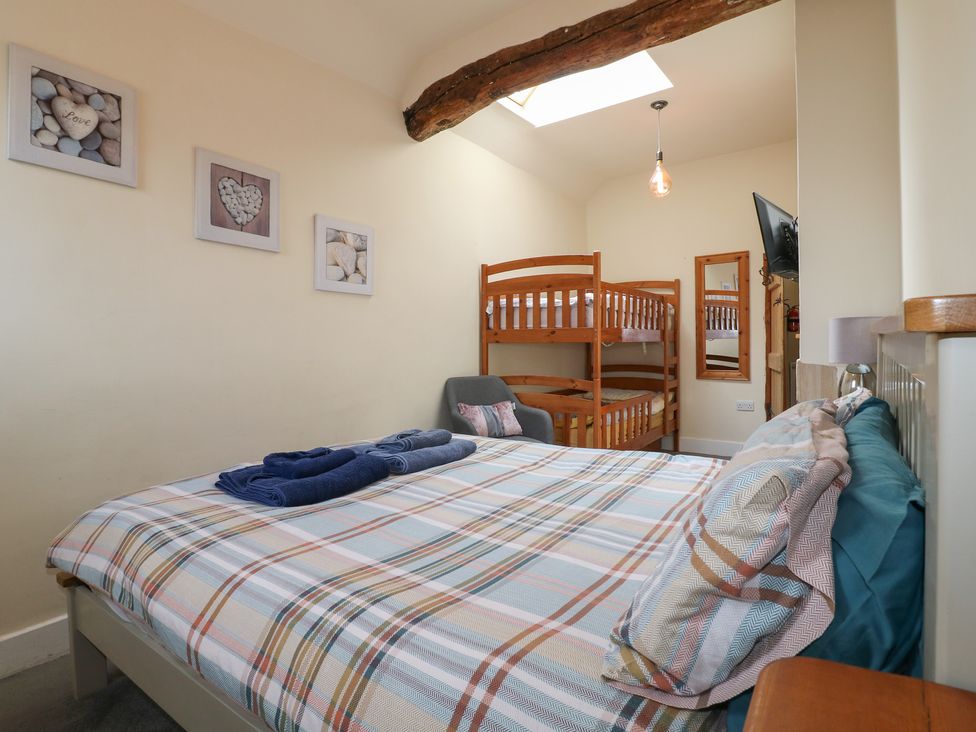 A bedroom with a bed and a bunk bed at Milford Cottage in Milford near Duffield