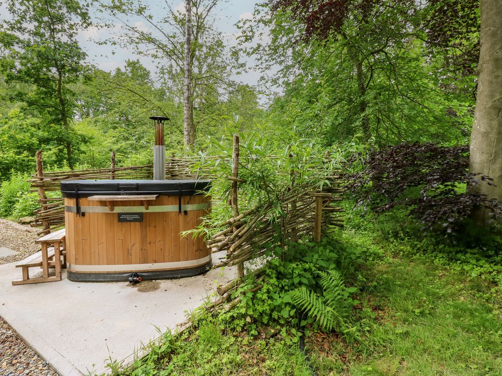 A hot tub surrounded by plants and a wooden fence at Bracken Fern in Eppleby