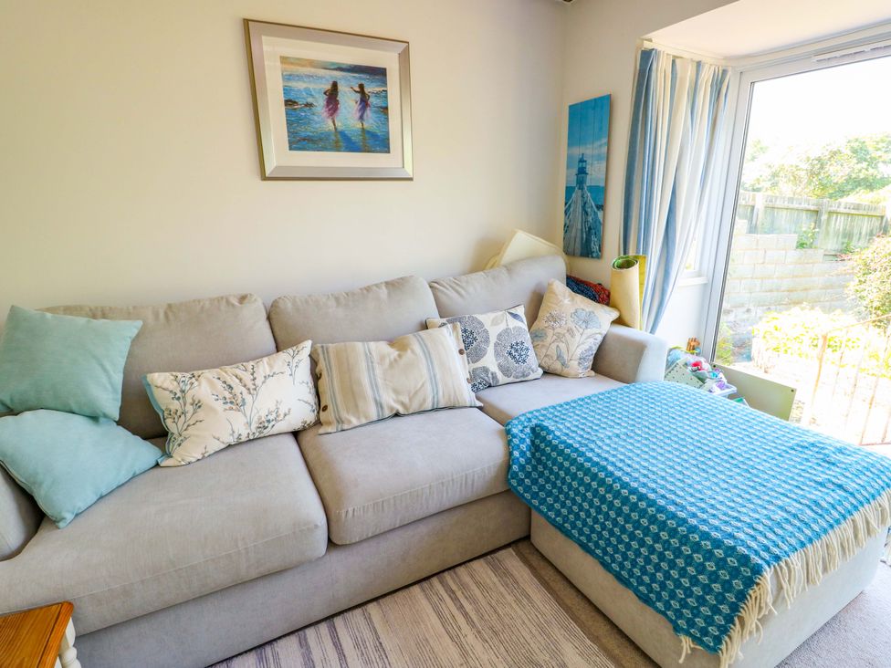 A living room with a sofa and cushions at Bryn Pydew in Llandudno Junction