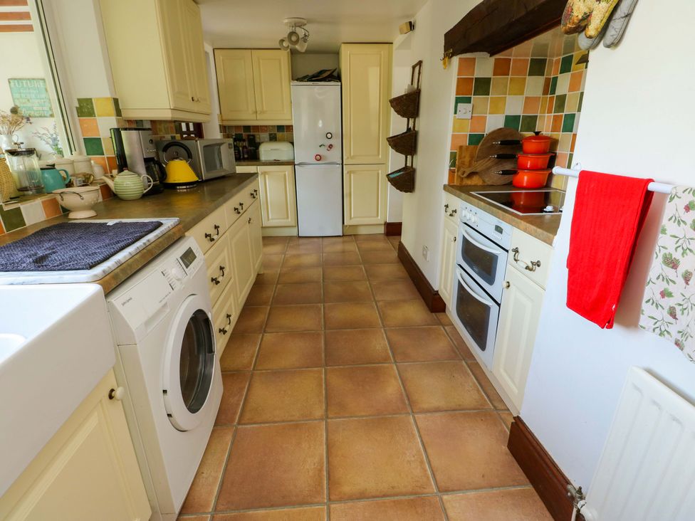 A kitchen with appliances and cabinets at Bryn Pydew in Llandudno Junction