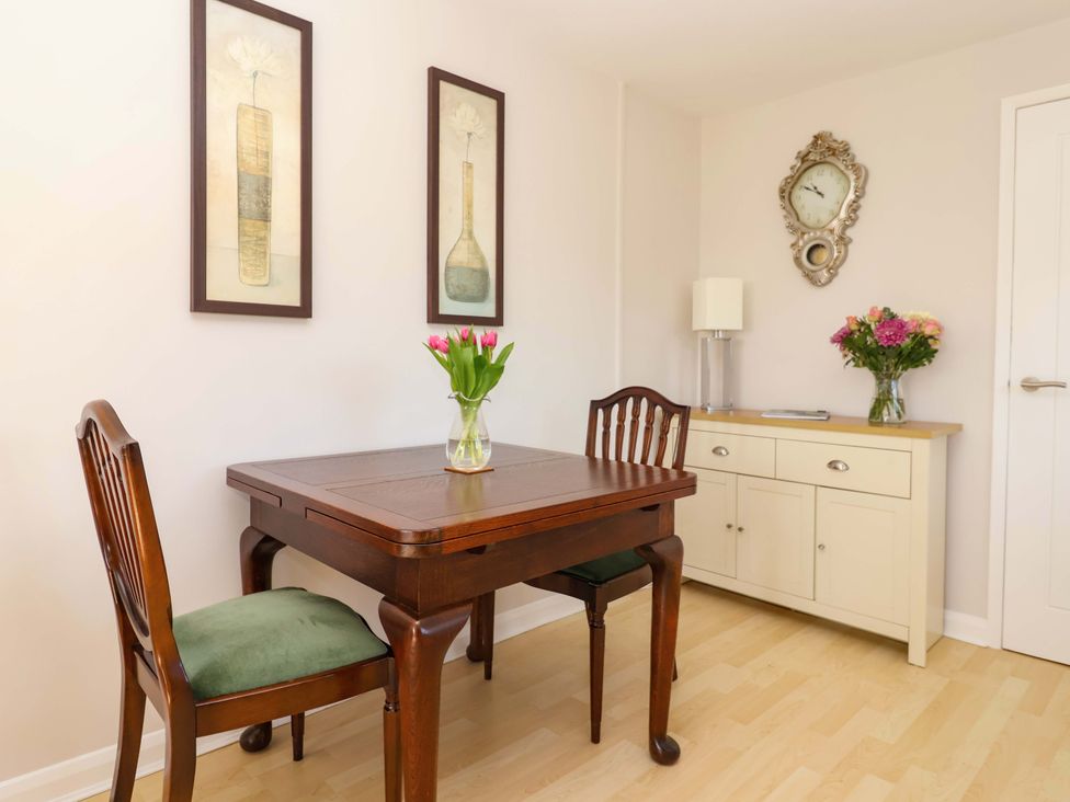 A dining room with a table and two chairs at Cartwheel Cottage in Yearsley