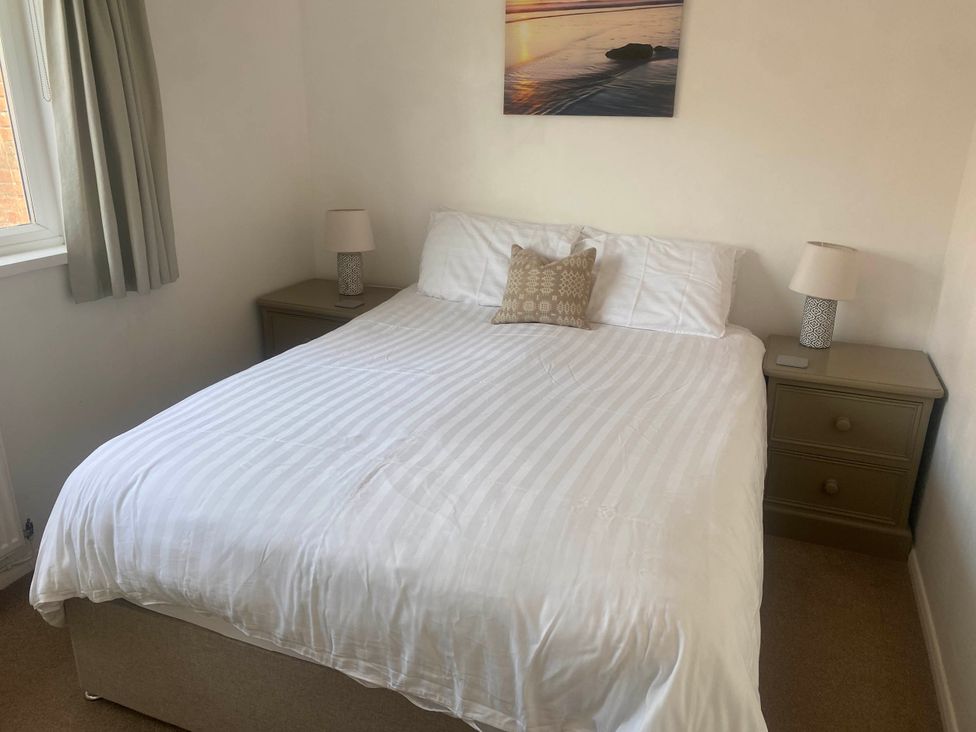 A bedroom with a bed and nightstand at Valley High in Solva
