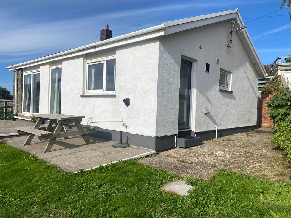 A house with a picnic table and grass at Valley High in Solva