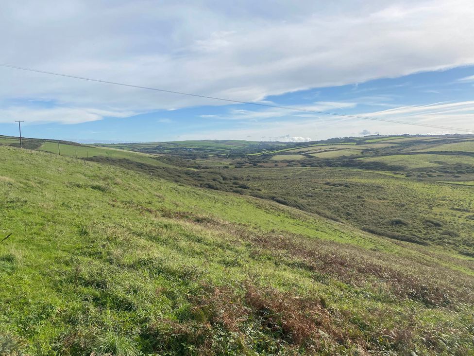 A landscape view of hills and electric poles at Valley High Solva