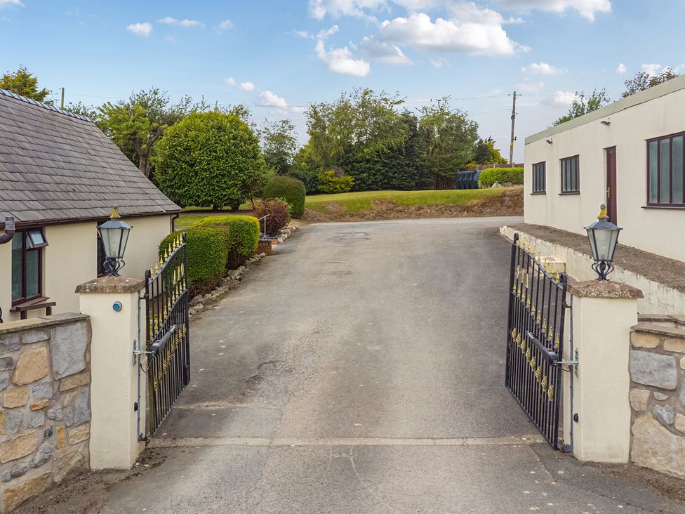 An entrance with gates and driveway at Arosfa Axton near Trelawynd