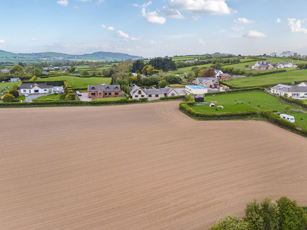 An aerial view of houses and fields at Arosfa in Axton near Trelawynd
