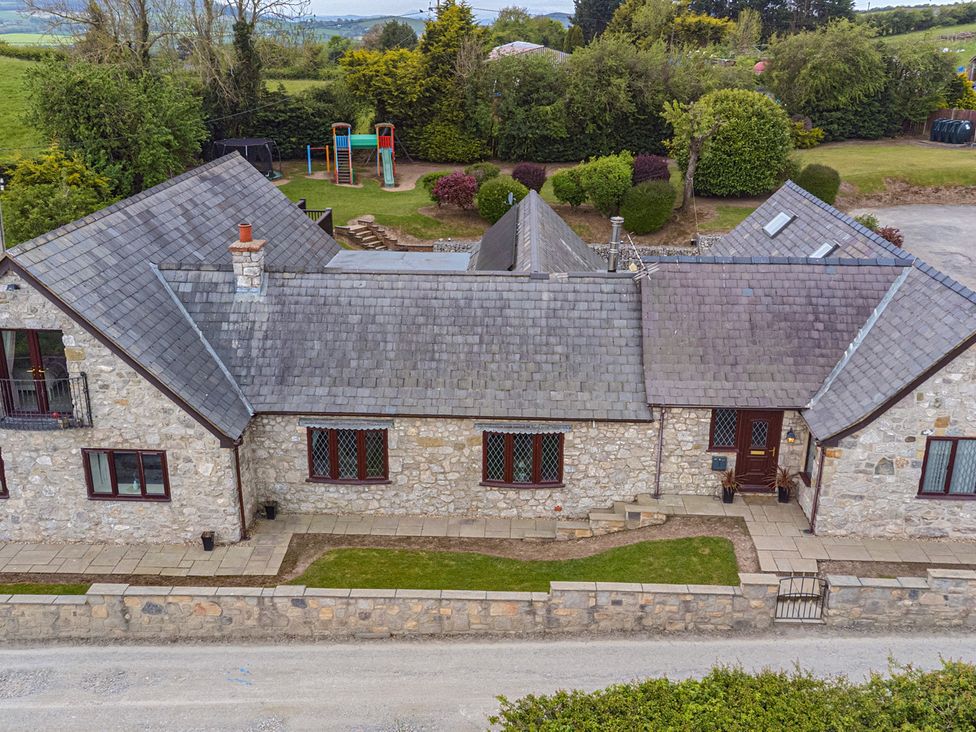 An aerial view of a house with a patio and garden at Arosfa in Axton near Trelawynd