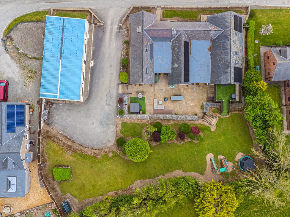 An outdoor area with a garden and patio at Arosfa in Axton near Trelawynd