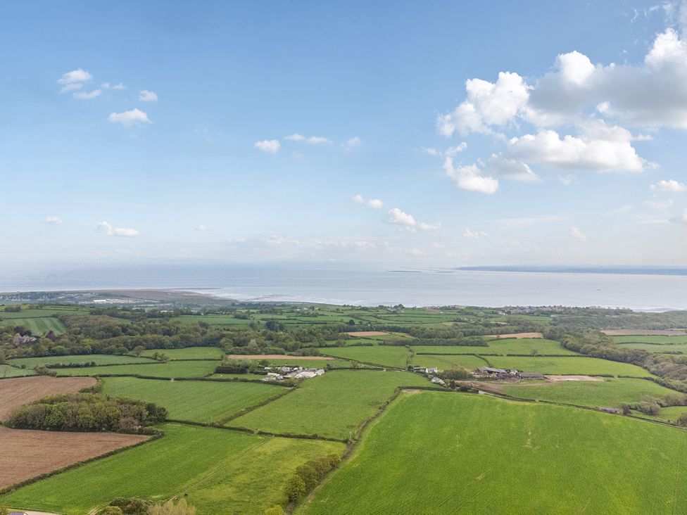 An aerial view of fields and water at Arosfa in Axton near Trelawynd