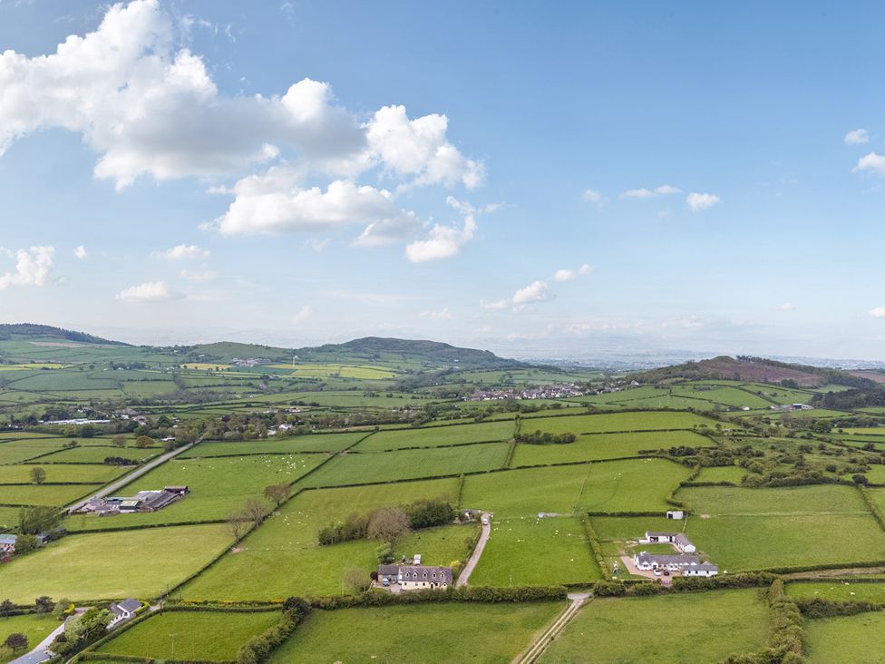 A landscape view with fields and houses at Arosfa Axton near Trelawynd