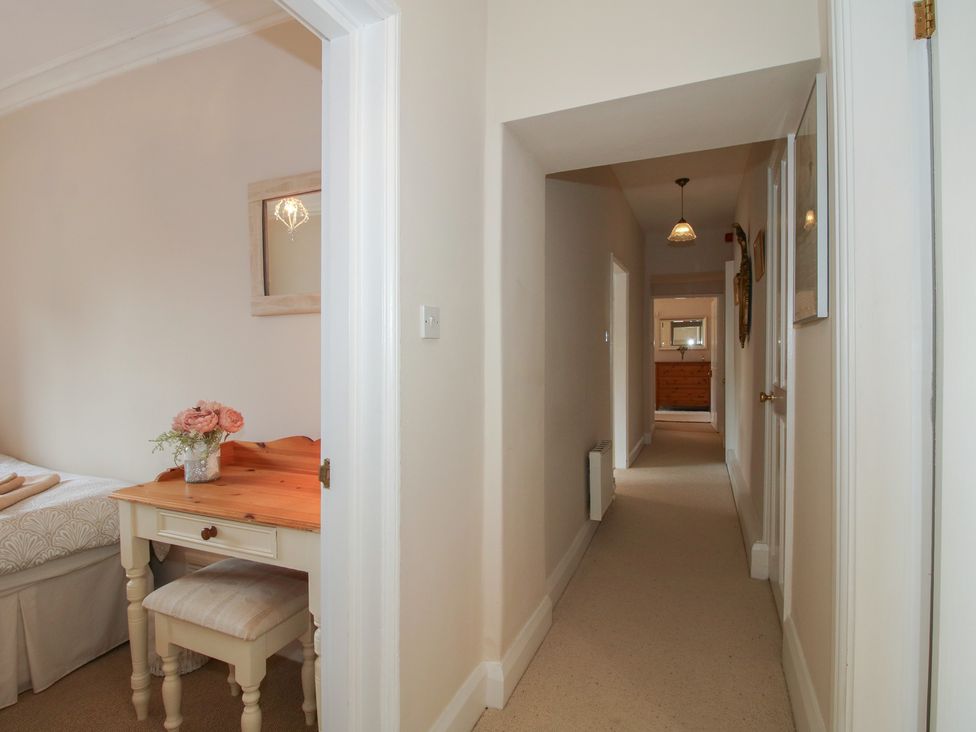 A hallway with a table and mirror at The Old Nursery in Bourton near Much Wenlock
