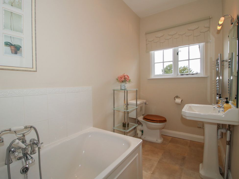 A bathroom with a bathtub, toilet, and sink at The Old Nursery in Bourton near Much Wenlock