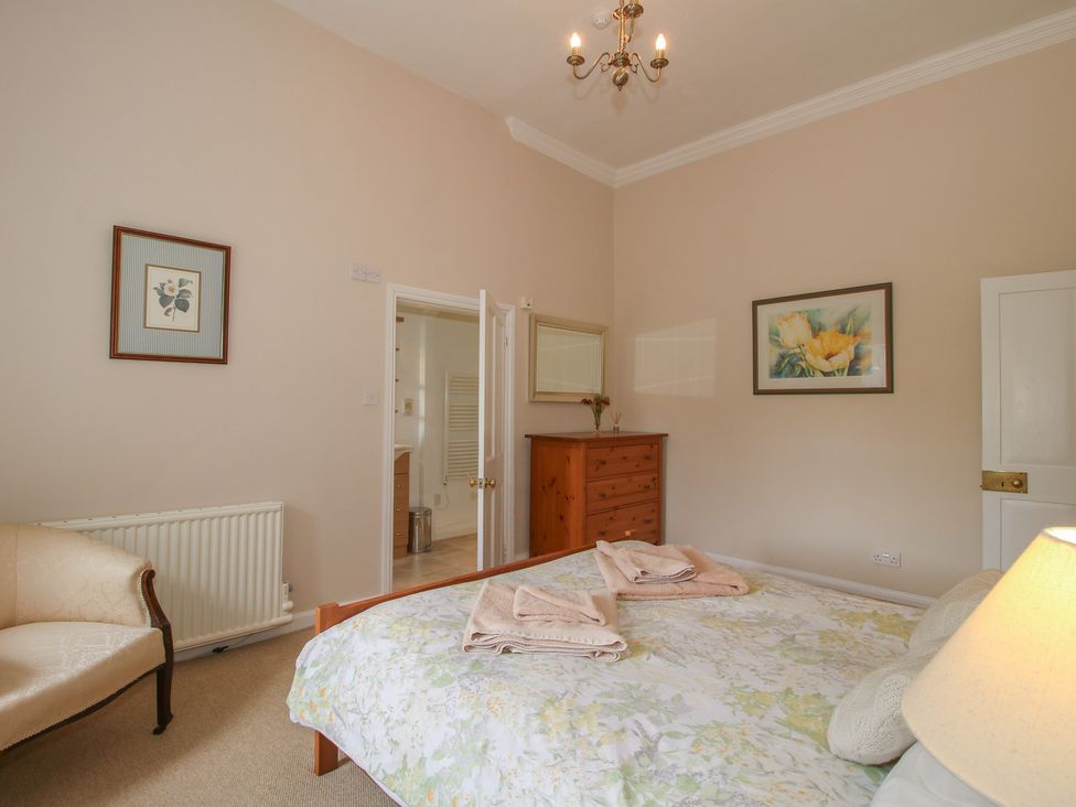 A bedroom with a bed and chest of drawers at The Old Nursery in Bourton near Much Wenlock