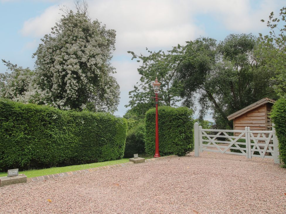 An outdoor area with trees and a wooden gate at The Old Nursery Bourton near Much Wenlock