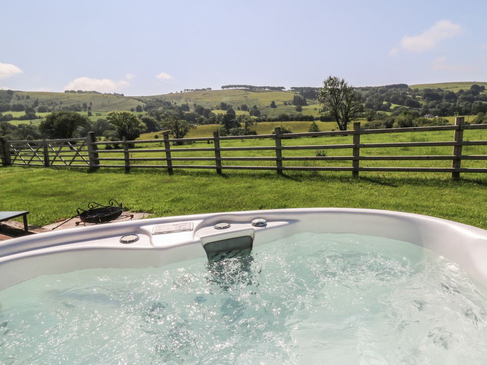 A hot tub with a view of the landscape at Bwthyn Bach Brefi