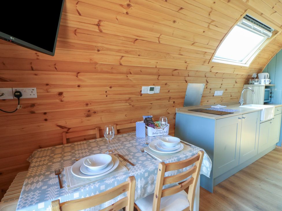 A kitchen with a dining table and chairs at Bwthyn Bach Brefi