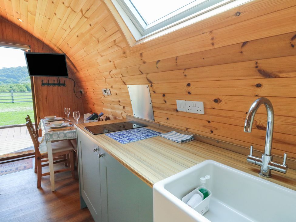 A kitchen with a sink and stove at Bwthyn Bach Brefi