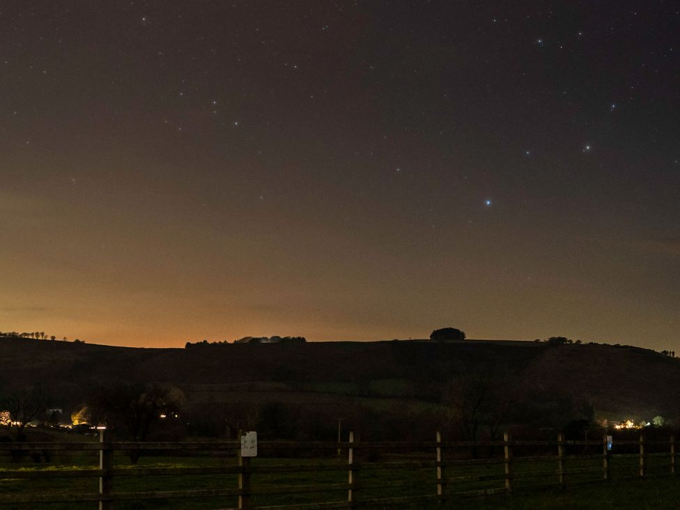 A view of a night sky with stars and hills at Bwthyn Bach Brefi