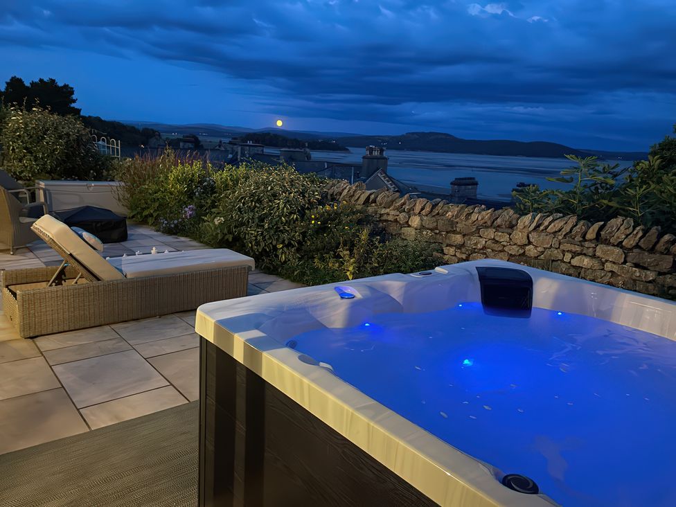 A hot tub with outdoor furniture and a view at Victoria Mount in Grange-Over-Sands