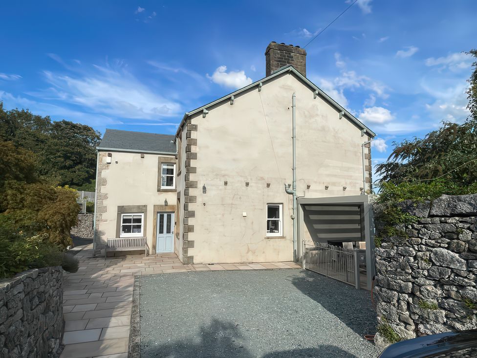 A house with a bench and carport at Victoria Mount in Grange-Over-Sands