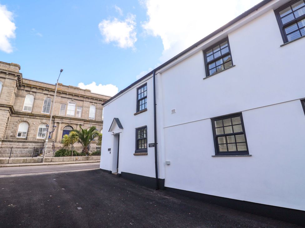 A building with windows and a door next to a street at 21 Alverton Street in Penzance