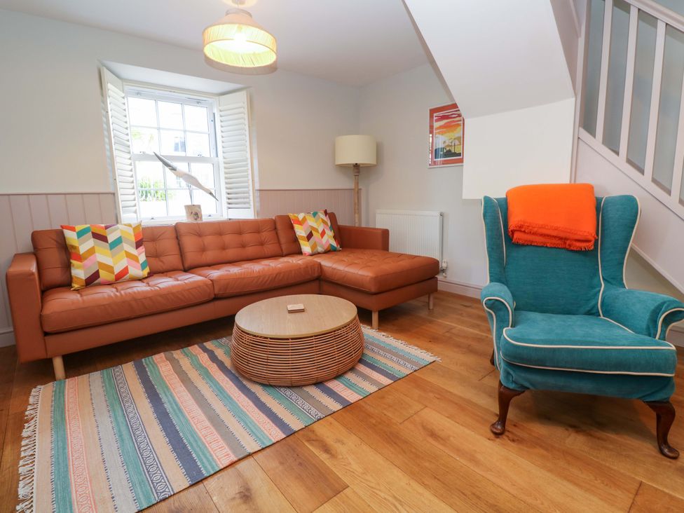 A living room with a sofa coffee table and armchair at 21 Alverton Street Penzance