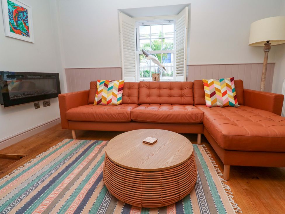 A living room with a sofa and coffee table at 21 Alverton Street Penzance