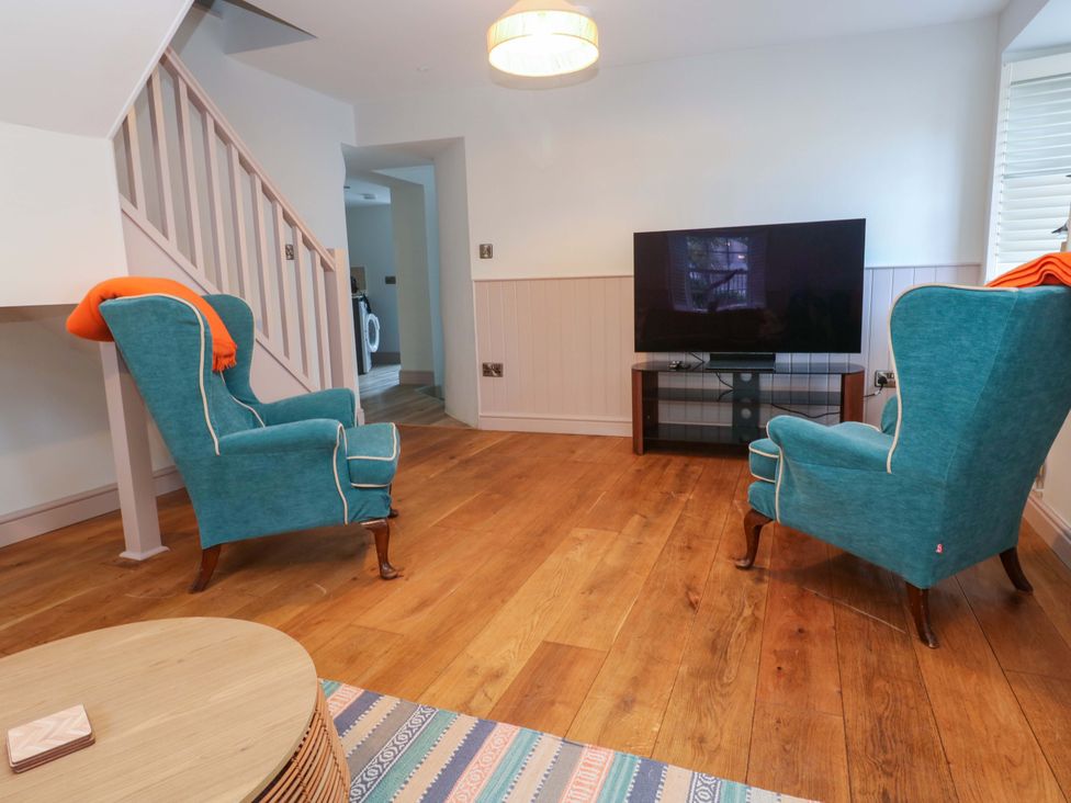 A living room with two chairs and a television at 21 Alverton Street in Penzance