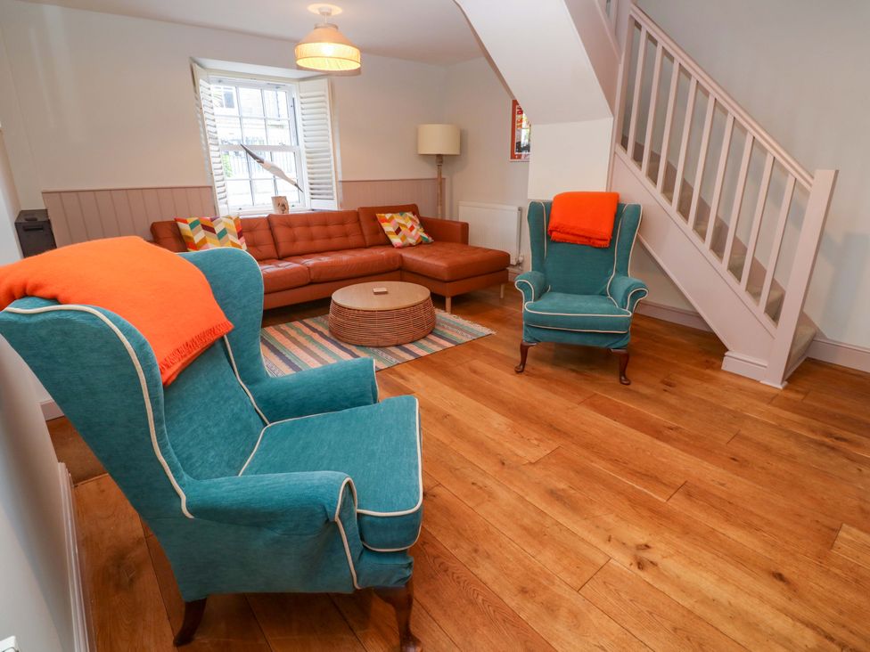 A living room with a sofa and armchairs at 21 Alverton Street Penzance