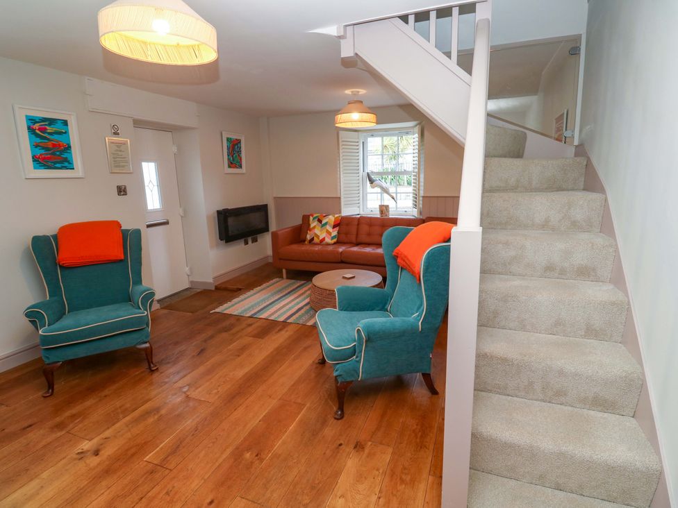 A living room with an armchair and sofa at 21 Alverton Street in Penzance