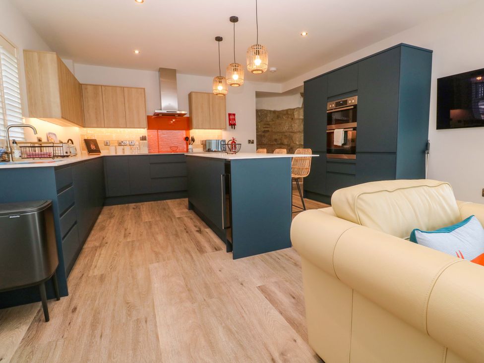 A kitchen with cabinets, island and appliances at 21 Alverton Street in Penzance