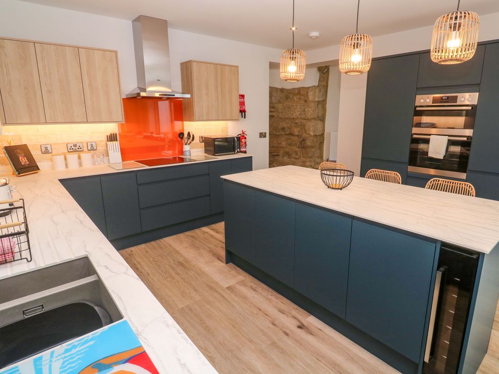 A kitchen with cabinets and appliances at 21 Alverton Street Penzance