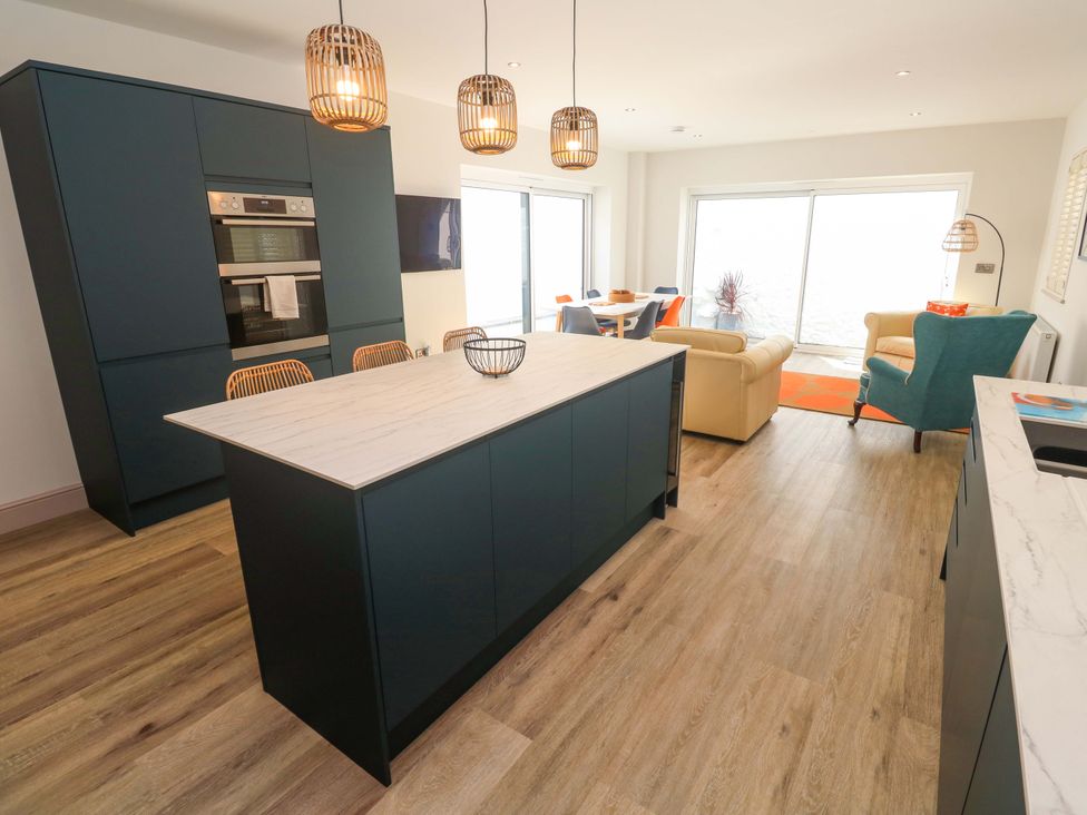 A kitchen with an island and dining area at 21 Alverton Street Penzance
