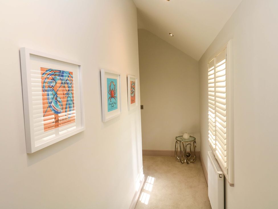 A hallway with framed artwork on the wall at 21 Alverton Street in Penzance
