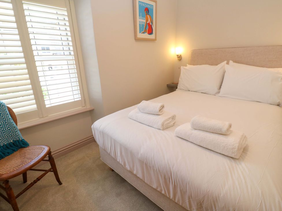 A bedroom with a bed and towels on it at 21 Alverton Street Penzance
