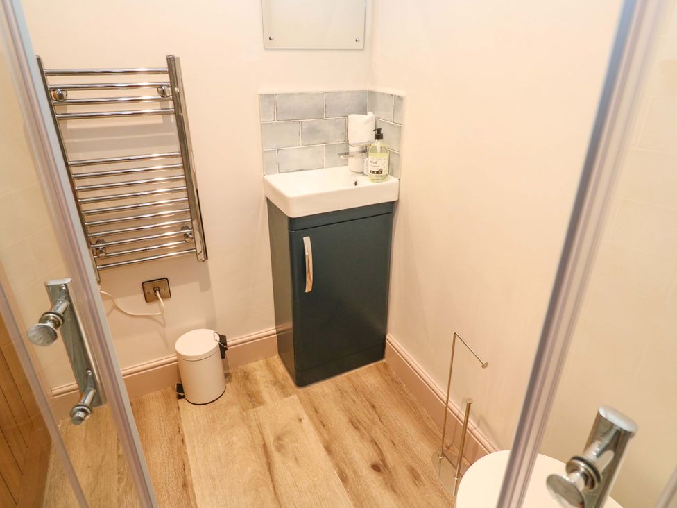 A bathroom with a sink and towel warmer at 21 Alverton Street Penzance